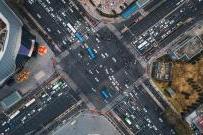 Aerial view of busy city intersection with traffic moving in both directions